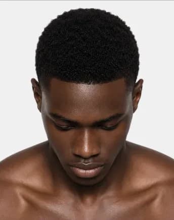 AI beauty portrait of the same Black male model looking down, showing natural skin detail